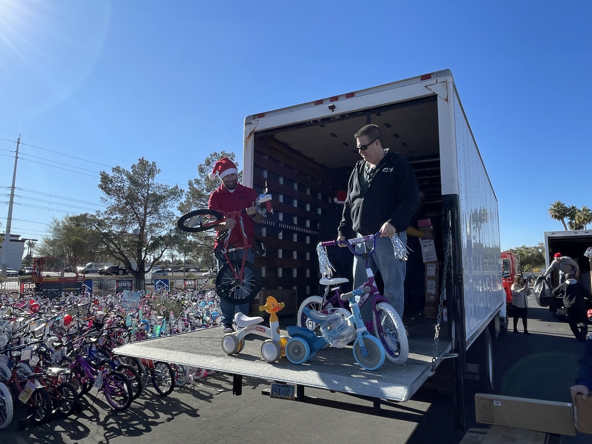Photos of PT's Taverns donations to 98.5 KLUC annual toy drive